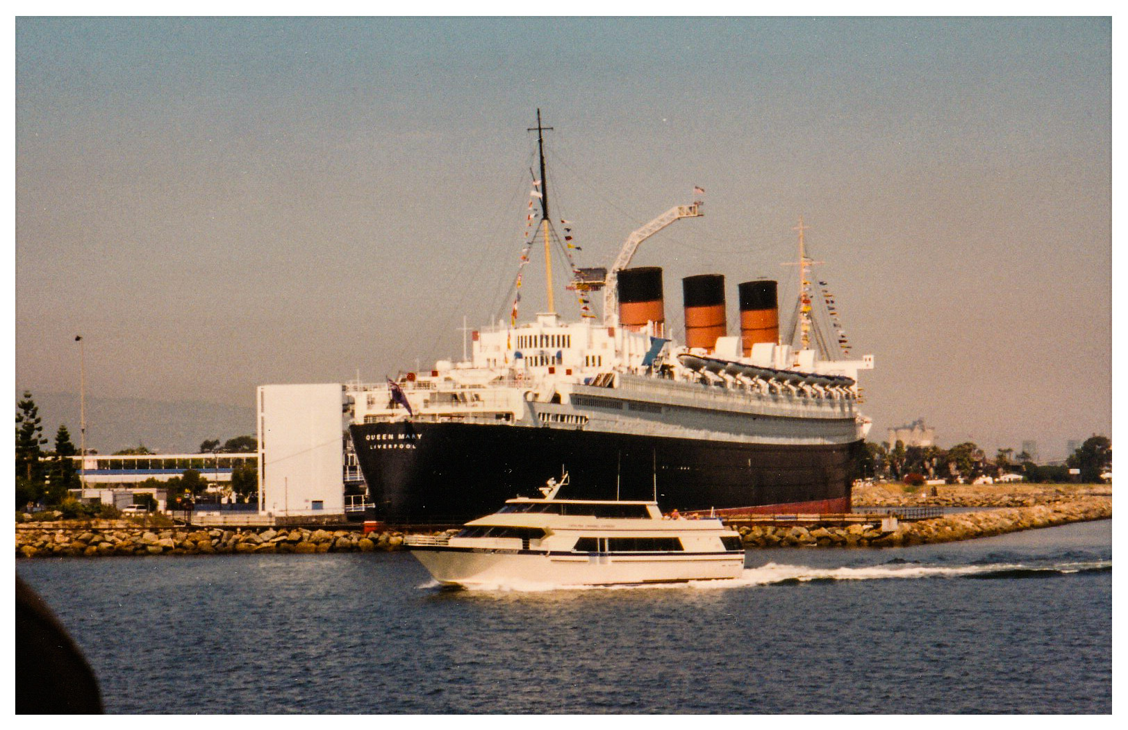 A boat is in the water near a large ship.