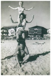 A man and two women are on the beach